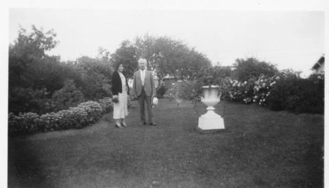 Nester and Covey family - man and wife standing in the garden